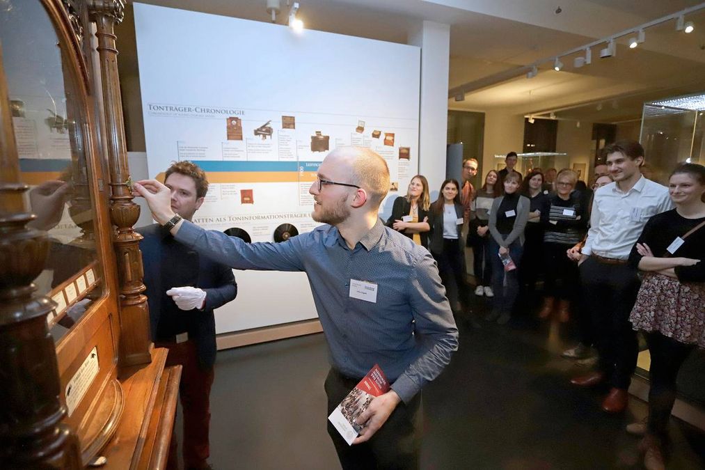 enlarge the image: Ein Musikautomat wird vor einer Menge von Menschen aufgeschlossen